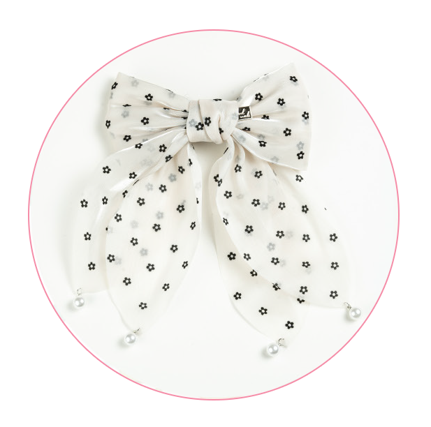 Decorative hair bow accessory featuring a delicate and charming design